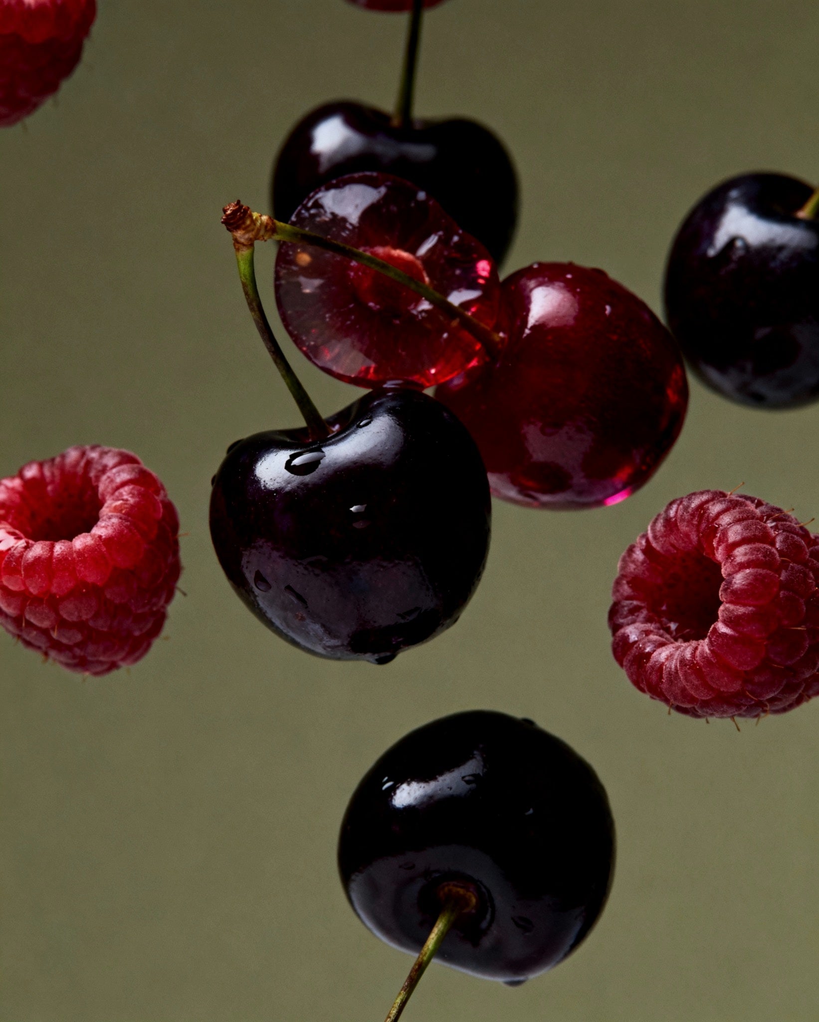 Close-up of cherries and raspberries against a neutral background