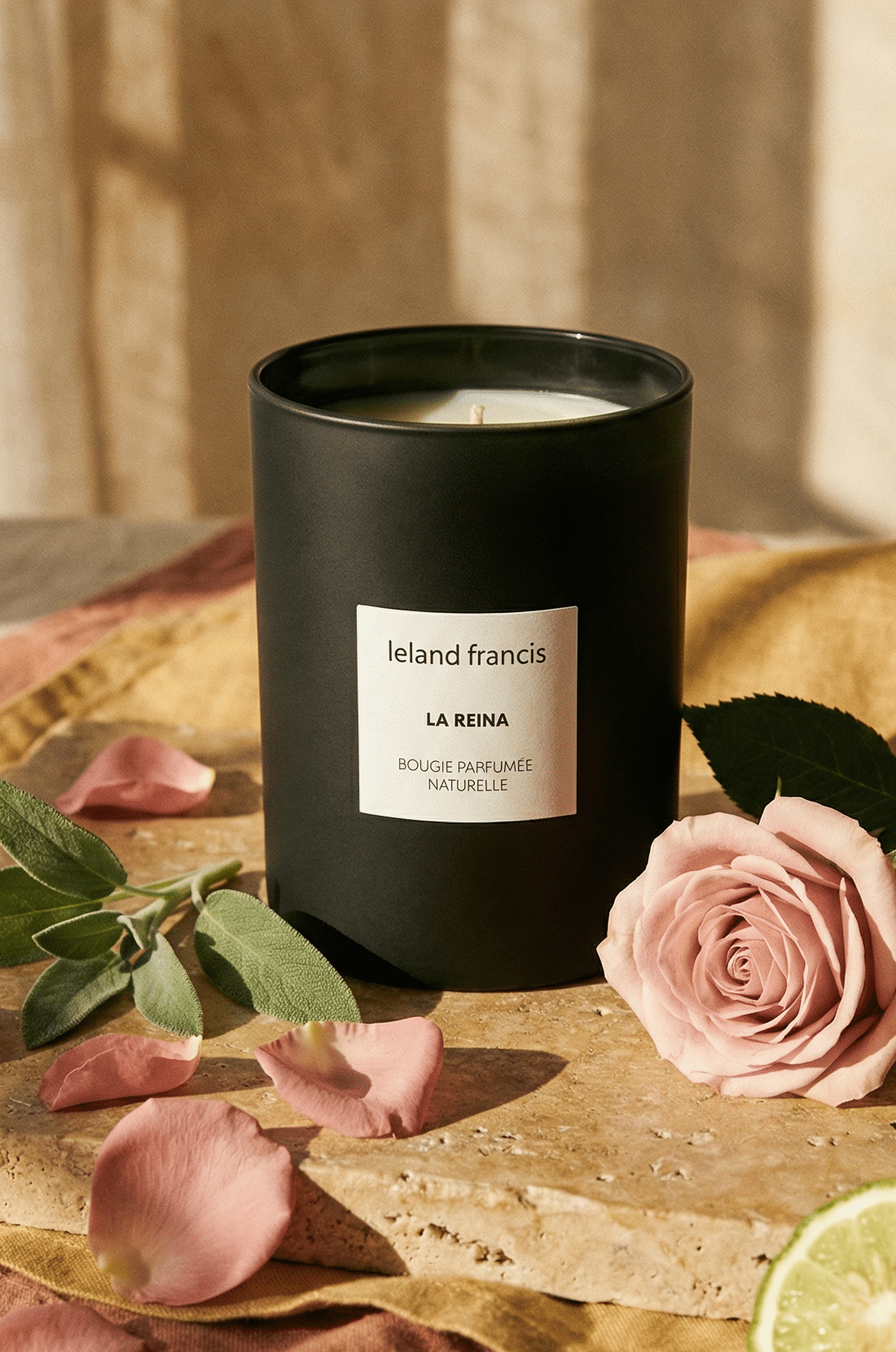 GREEN CANDLE with LELAND FRANCIS LA REINA on a table with pink roses and BERGAMOTS