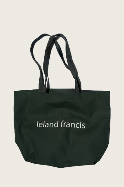 Black tote bag with 'Ieland Francis' branding on a white background