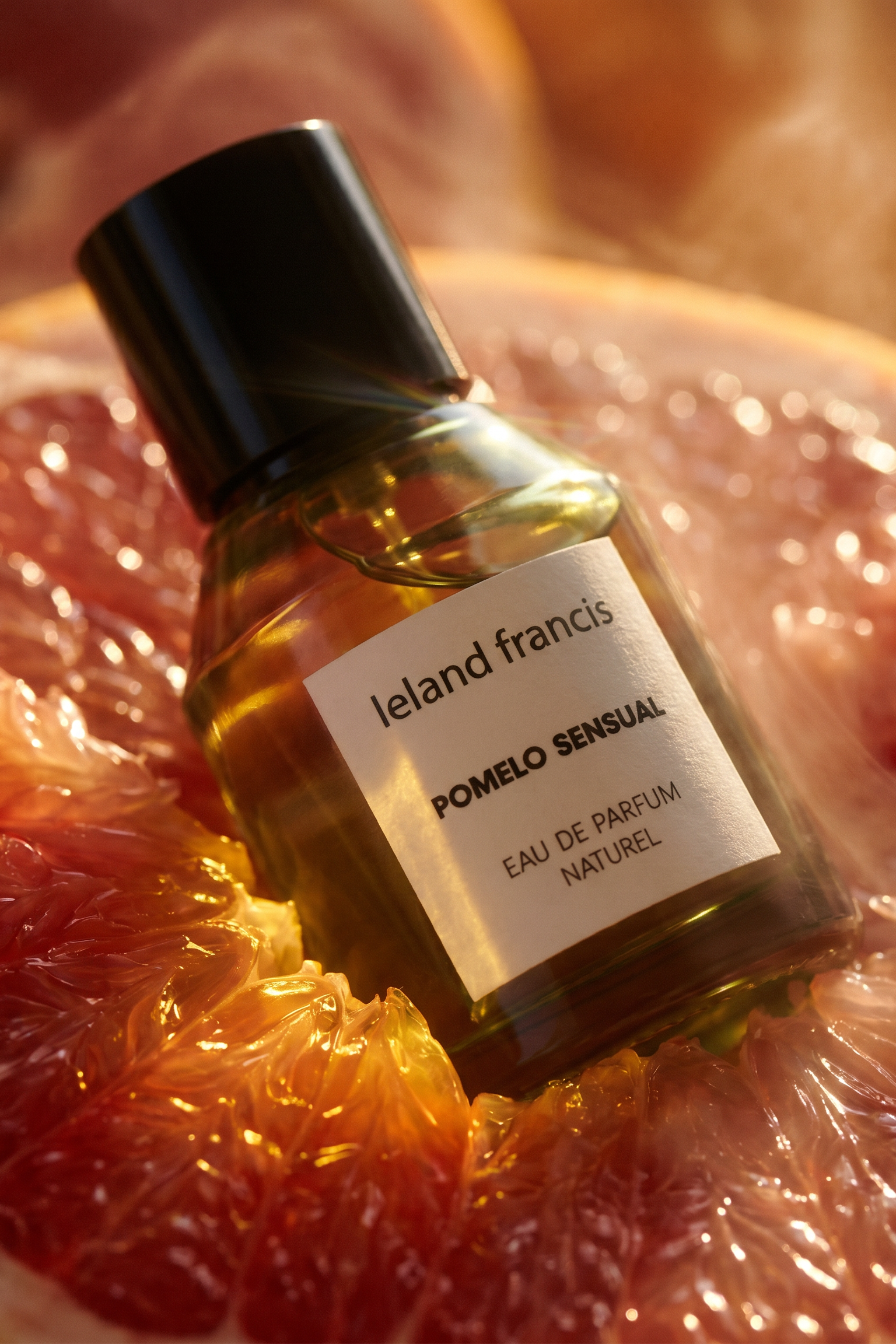 Bottle of Ieland Francis Pomelo Sensual perfume on a grapefruit slice