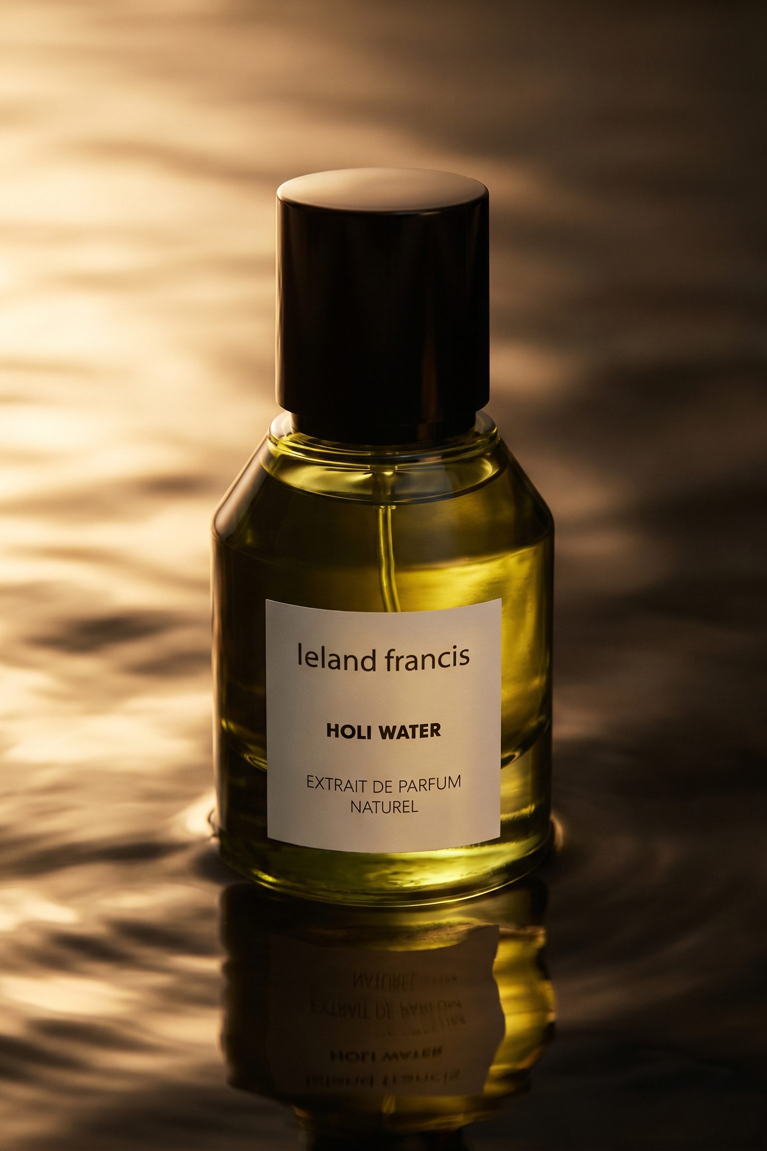 Bottle of Ieland Francis Holi Water perfume with a reflective surface